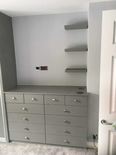 Chest of drawers and wall shelves.